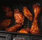 Close-up of Crispy Air Fryer Chicken Wings Cooking in Air Fryer Basket