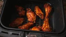 Close-up of Crispy Air Fryer Chicken Wings Cooking in Air Fryer Basket