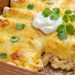 A serving of the best white chicken enchiladas, showing the creamy interior and golden cheese top.